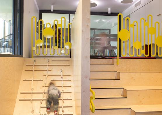 a child climbing up a wooden staircase