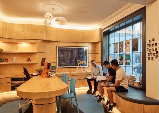 a group of people sitting on a counter in a room