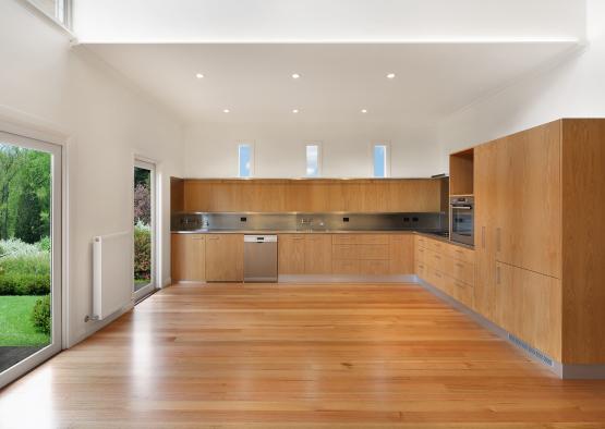 a kitchen with wood cabinets and a wood floor