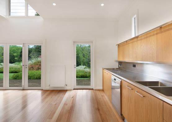 a kitchen with wood cabinets and a stainless steel sink