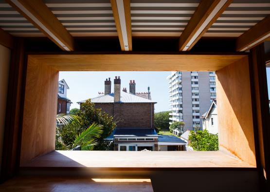 a window with a view of buildings and trees