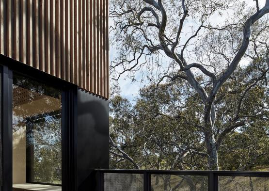 a building with a fence and trees