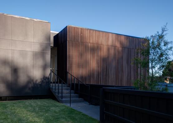 a building with a fence and stairs