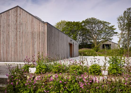 a building with a garden and trees