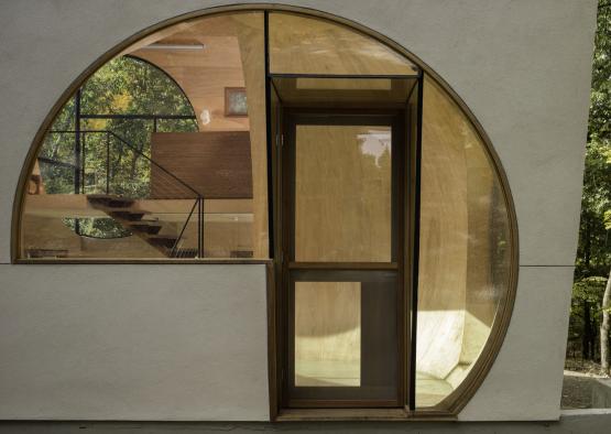 a circular doorway with a glass door