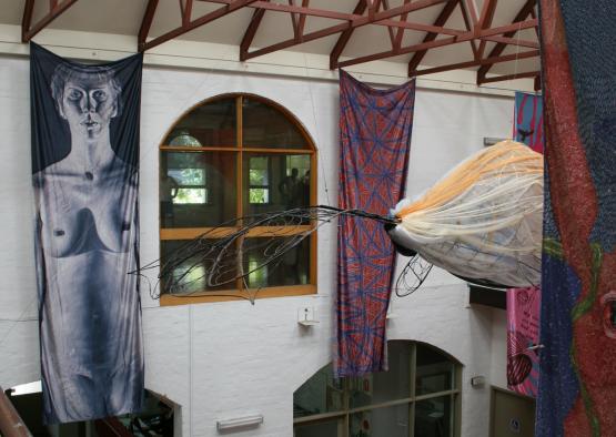 a large spider from the ceiling of a building