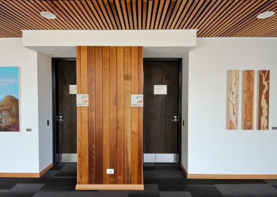 a room with two doors and a wood paneled wall