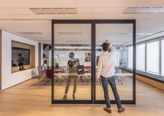 a man standing in front of glass doors