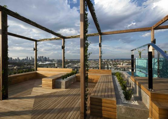 a wooden deck with a view of a city