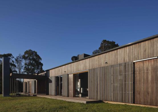 a building with a porch and grass