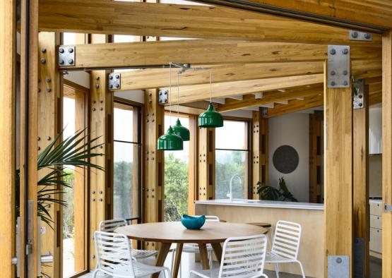 a dining table and chairs in a room with wood beams