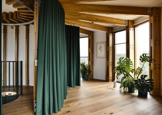 a room with green curtains and plants
