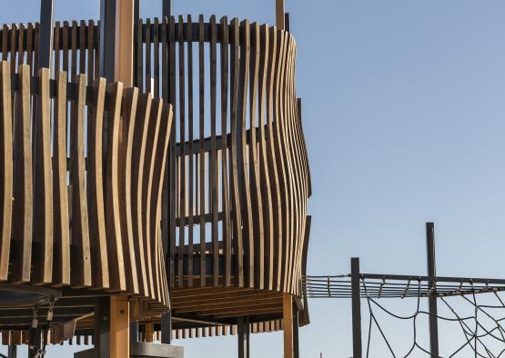 a wooden structure with a rope and a blue sky