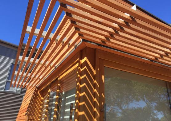 a wooden structure with a sun shade
