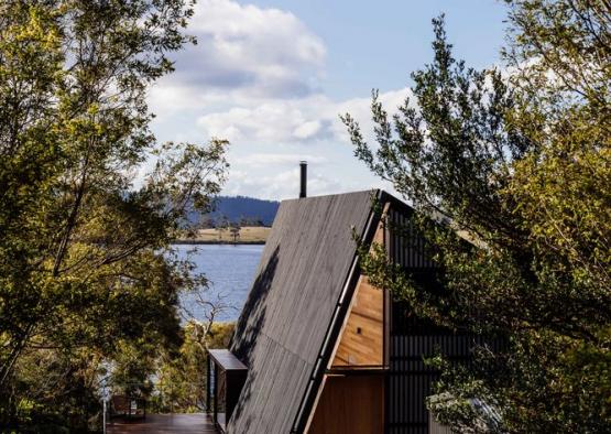 a house with a roof and trees around it