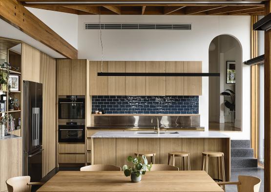 a kitchen with wood cabinets and a table