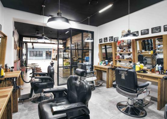 a barber shop with chairs and shelves