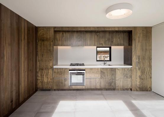 a kitchen with wood cabinets and a white ceiling