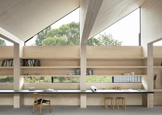 a room with a desk and shelves