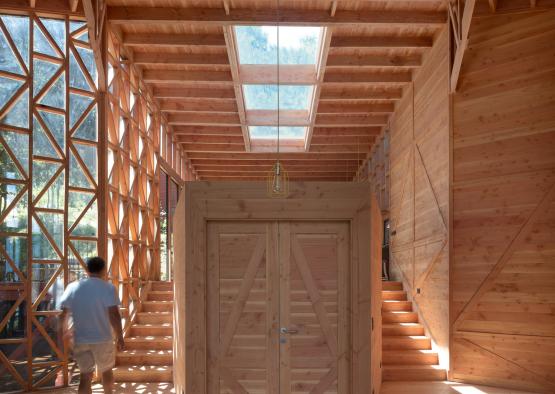 a man walking in a wooden building