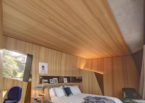 a bedroom with a wood paneled ceiling