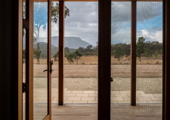 a wooden door with a view of a landscape