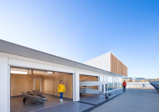 a building with a boat and a boat in the garage