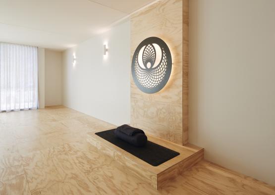 a room with a rug and a round object on the wall