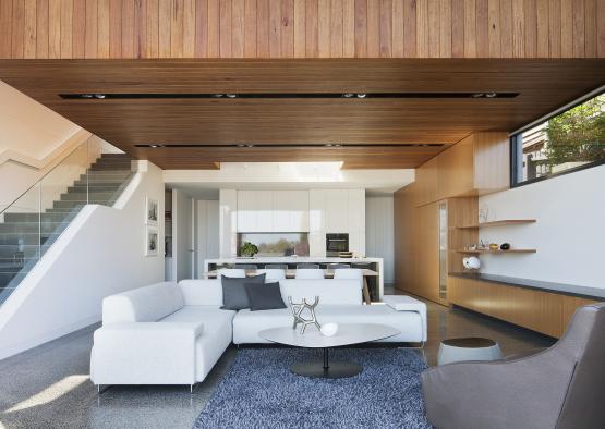 a living room with a white couch and a blue rug