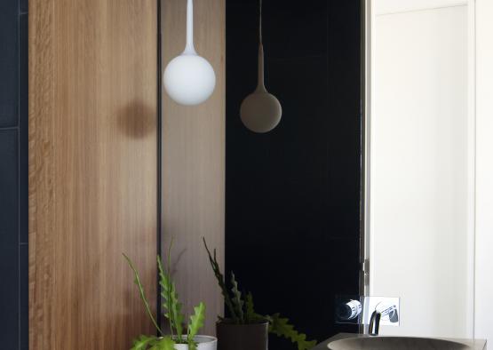 a sink and a plant in a bathroom