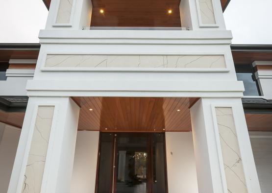 a white building with a wood roof