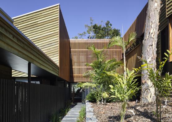 a building with a fence and plants