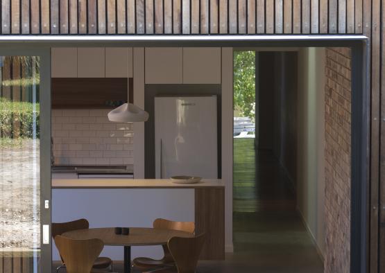 a kitchen and dining area with a table and chairs