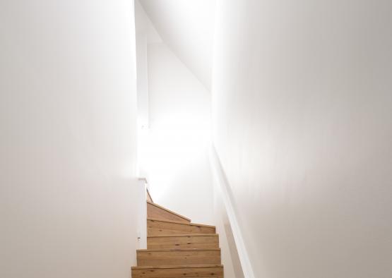 a wooden stairs in a white room