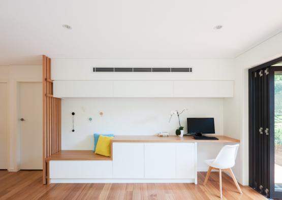 a white room with a desk and chair