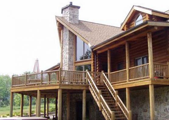 a log cabin with a large porch