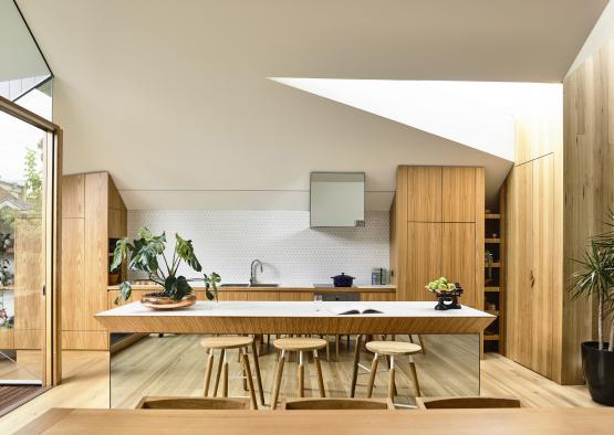 a kitchen with a table and stools