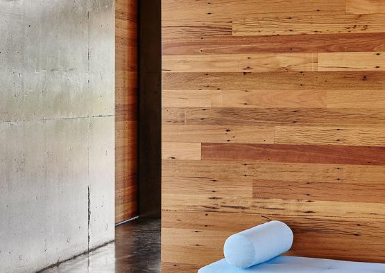 a wooden wall with a blue cushion