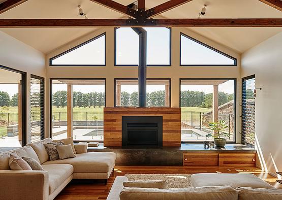 a living room with a fireplace and a large window