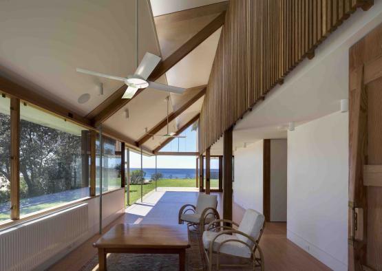 a room with a table and chairs and a ceiling fan