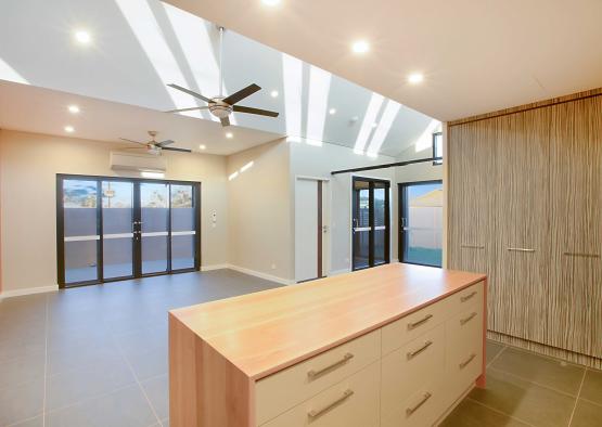 a room with a large counter and a ceiling fan