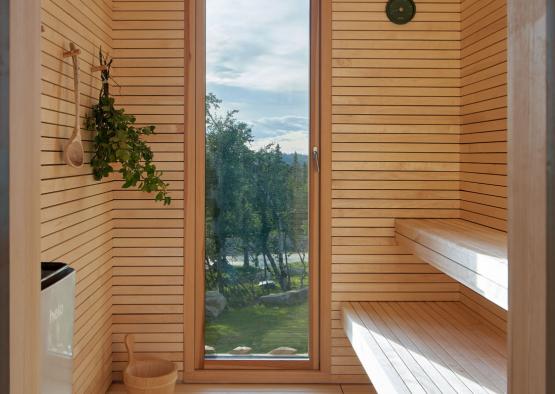 a wooden room with a window and a wood bench