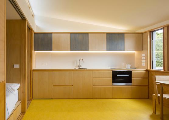 a kitchen with yellow floor and yellow carpet
