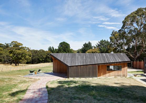 a building with a brick walkway and grass