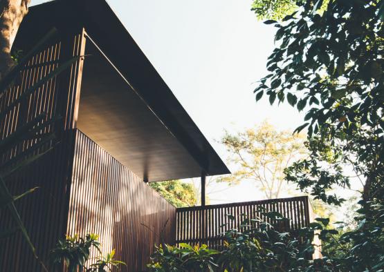 a building with a deck and trees