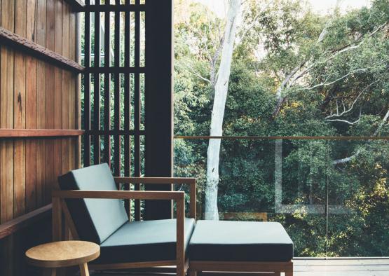 a chair and stool on a deck