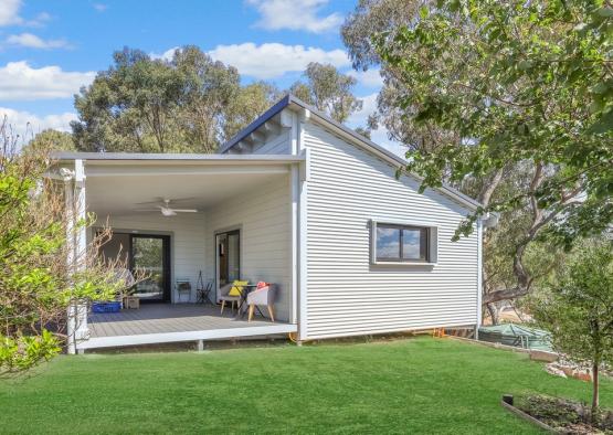 a house with a deck and a lawn