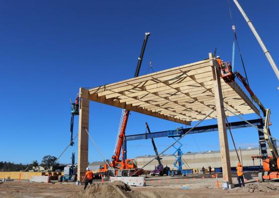 a construction site with cranes and a building