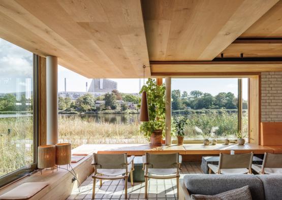 a room with a large window and a view of a river and trees