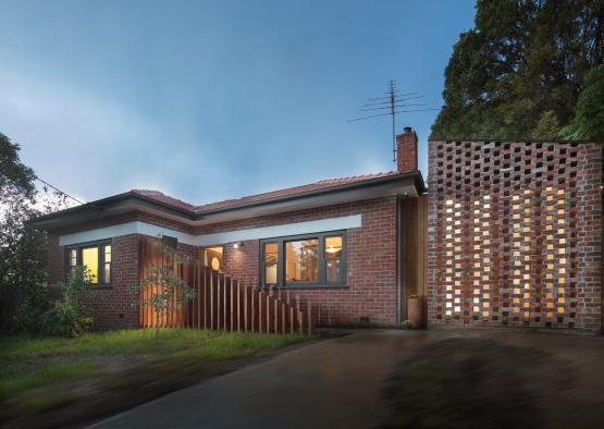 a brick house with a fence and a fence